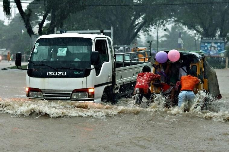 Eight dead in Philippine floods as thousands flee homes