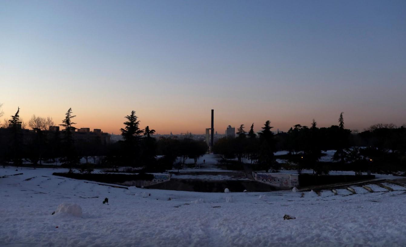 A lone person walks on accumulated snow at a public park in Madrid, Spain January 18, 2021. - Avaz