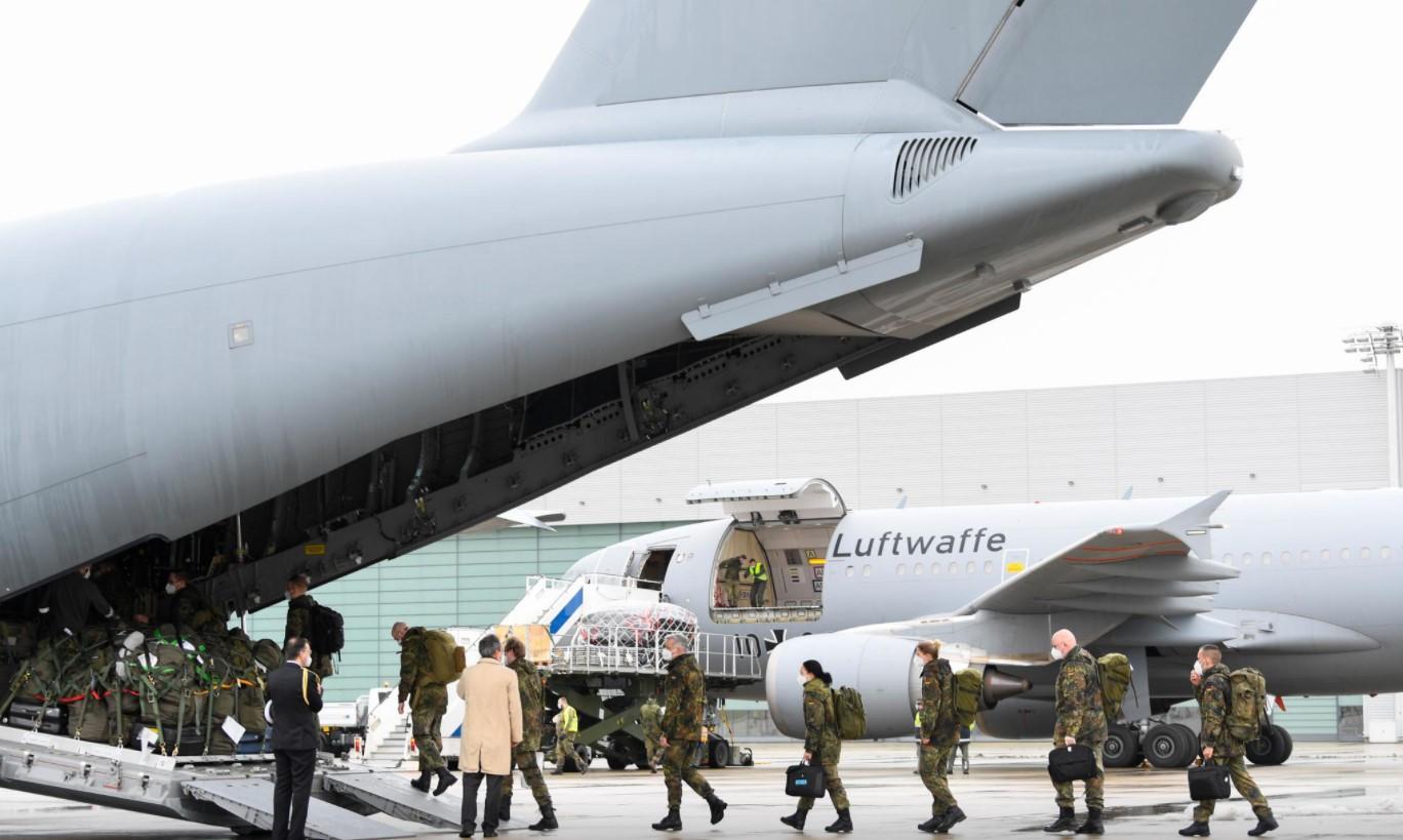 Staff members enter aboard an A400M military transport plane to COVID-19 stricken Portugal in Wunstorf, Germany, February 3, 2021. - Avaz