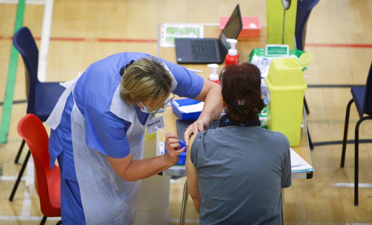 A woman receives an Oxford-AstraZeneca coronavirus disease (COVID-19) vaccine at a COVID-19 vaccination centre at Cwmbran Stadium in Cwmbran, South Wales, Britain February 17, 2021. - Avaz