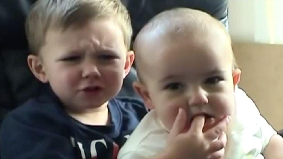 In the 55-second YouTube clip from 2007, a British toddler named Harry holds his baby brother Charlie - Avaz