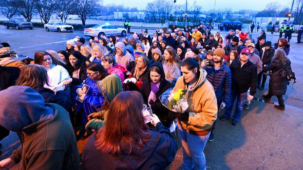 Fans line up to enter Graceland for a memorial service for Lisa Marie Presley Sunday, Jan. 22, 2023, in Memphis, Tenn. She died Jan. 12 after being hospitalized for a medical emergency and was buried on the property next to her son Benjamin Keough, and near her father Elvis Presley and his two parents - Avaz