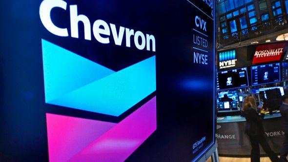 The logo for Chevron appears above a trading post on the floor of the New York Stock Exchange - Avaz